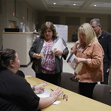 Image of two adults asking a question