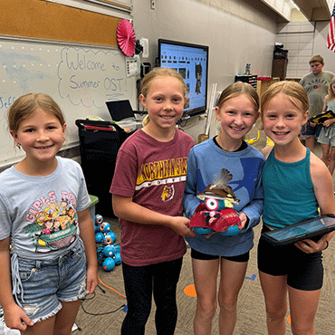 Group of girls showing off their project